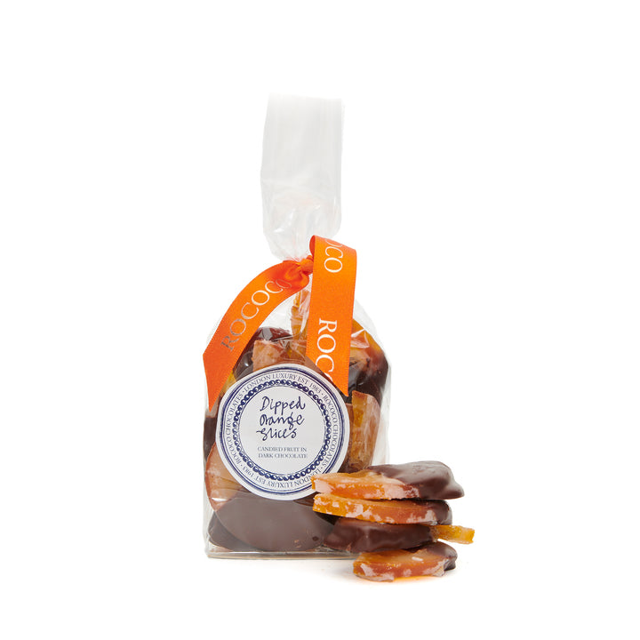 Rococo Chocolates Dipped Orange Slices. Candied orange slices, dipped in dark chocolate. Perfect Summer Treat. Buy orange chocolate online now.